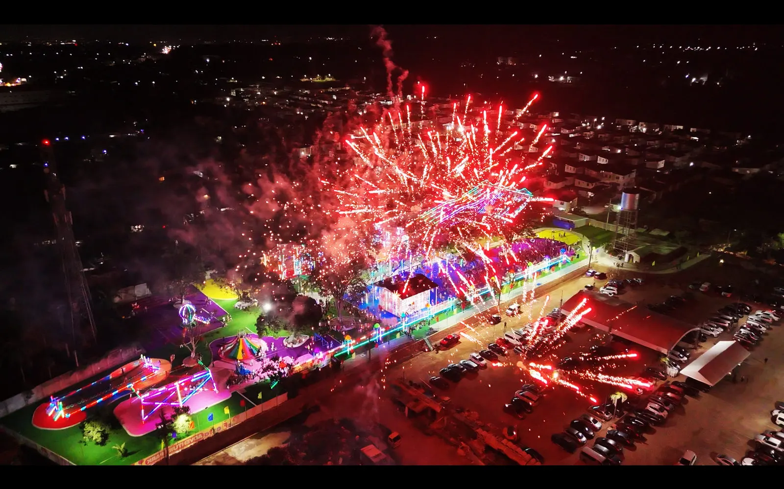 Red fireworks bursting over the park at night