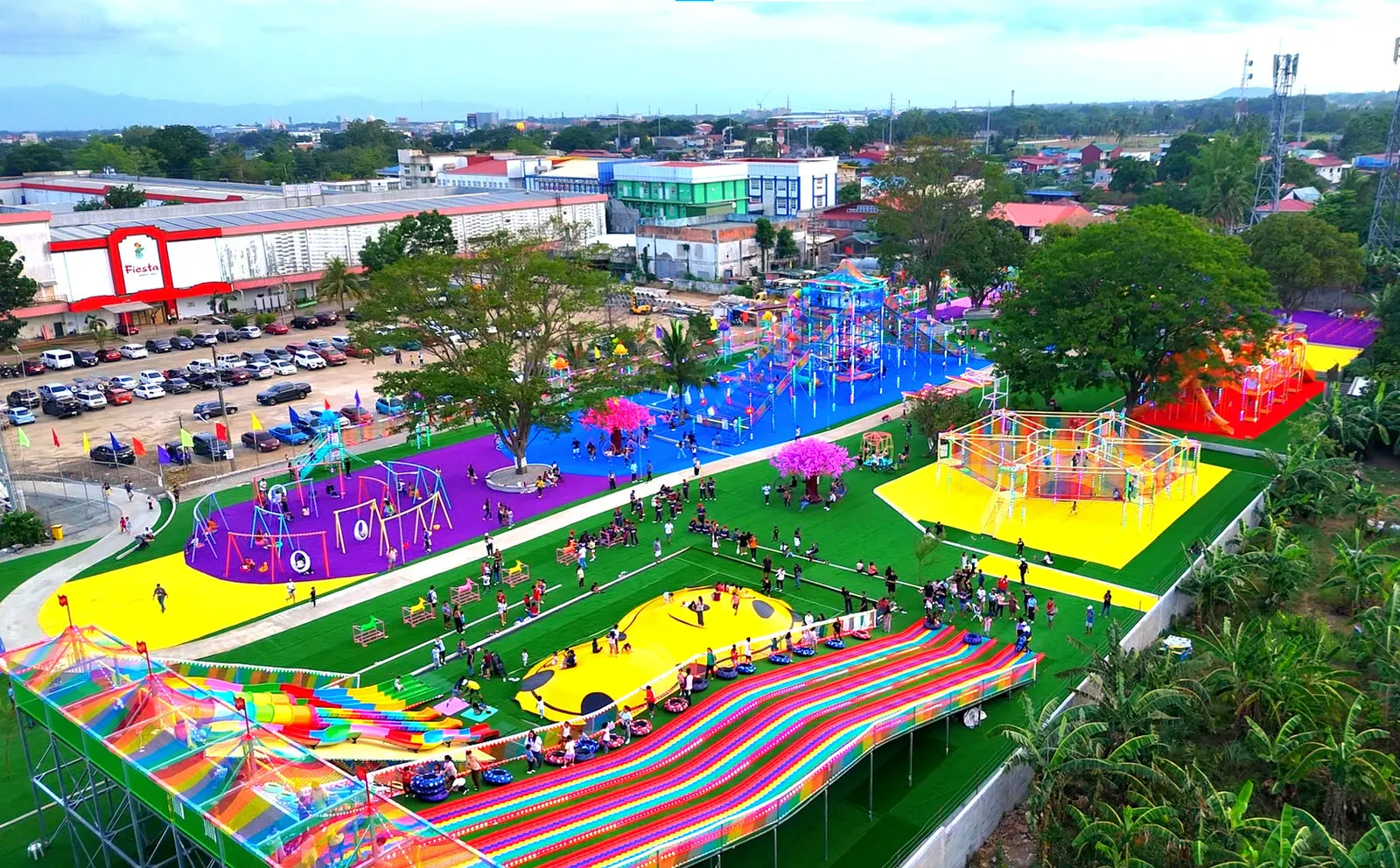 Daytime aerial view of the colorful park grounds and slides